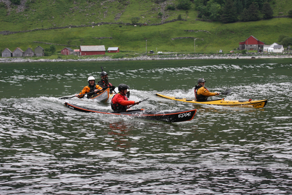 Three Edge Alnes kayaks riding the same wave in Hoddevik