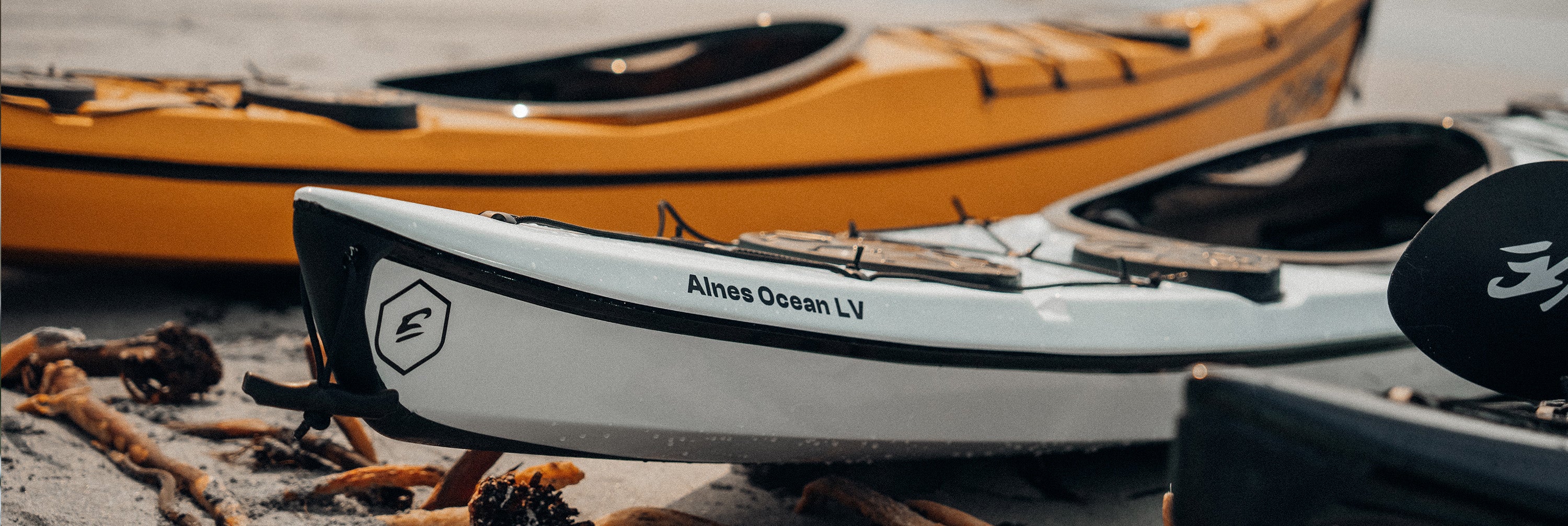 Edge Alnes kayaks resting on the beach
